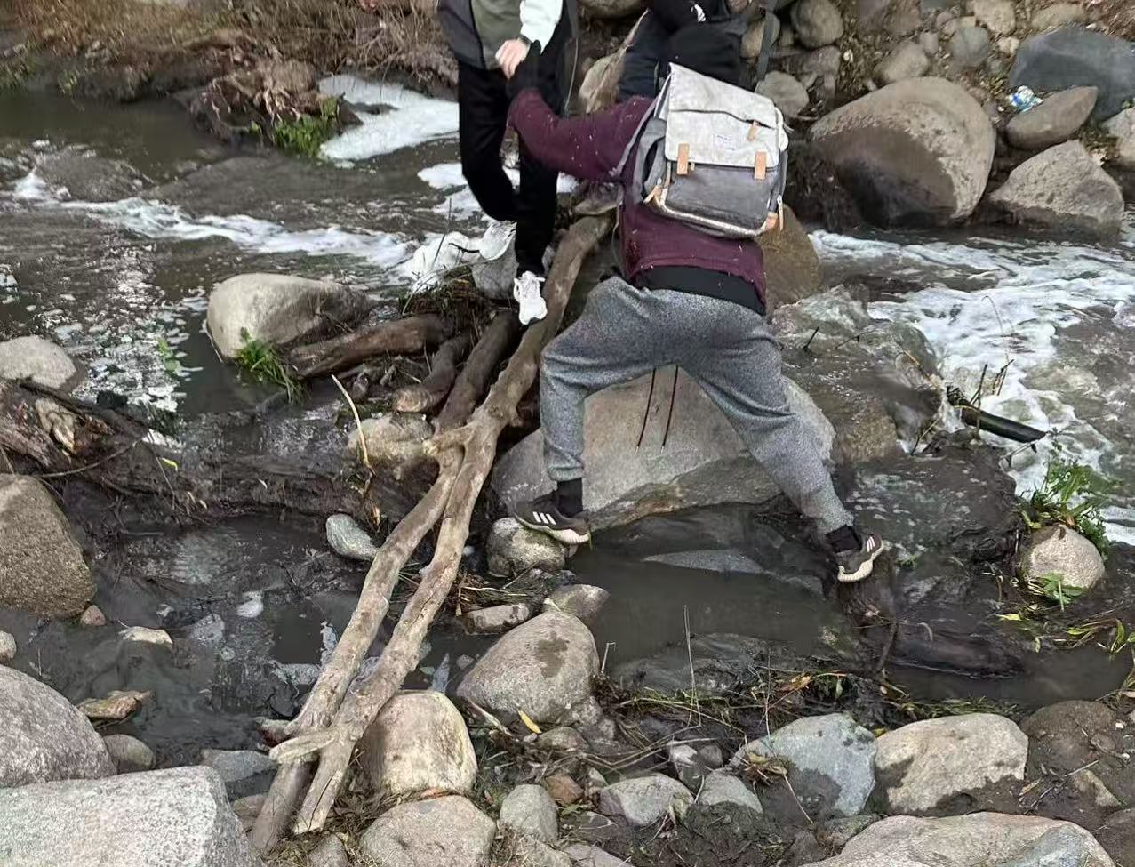 Zhang and his wife crossing the river