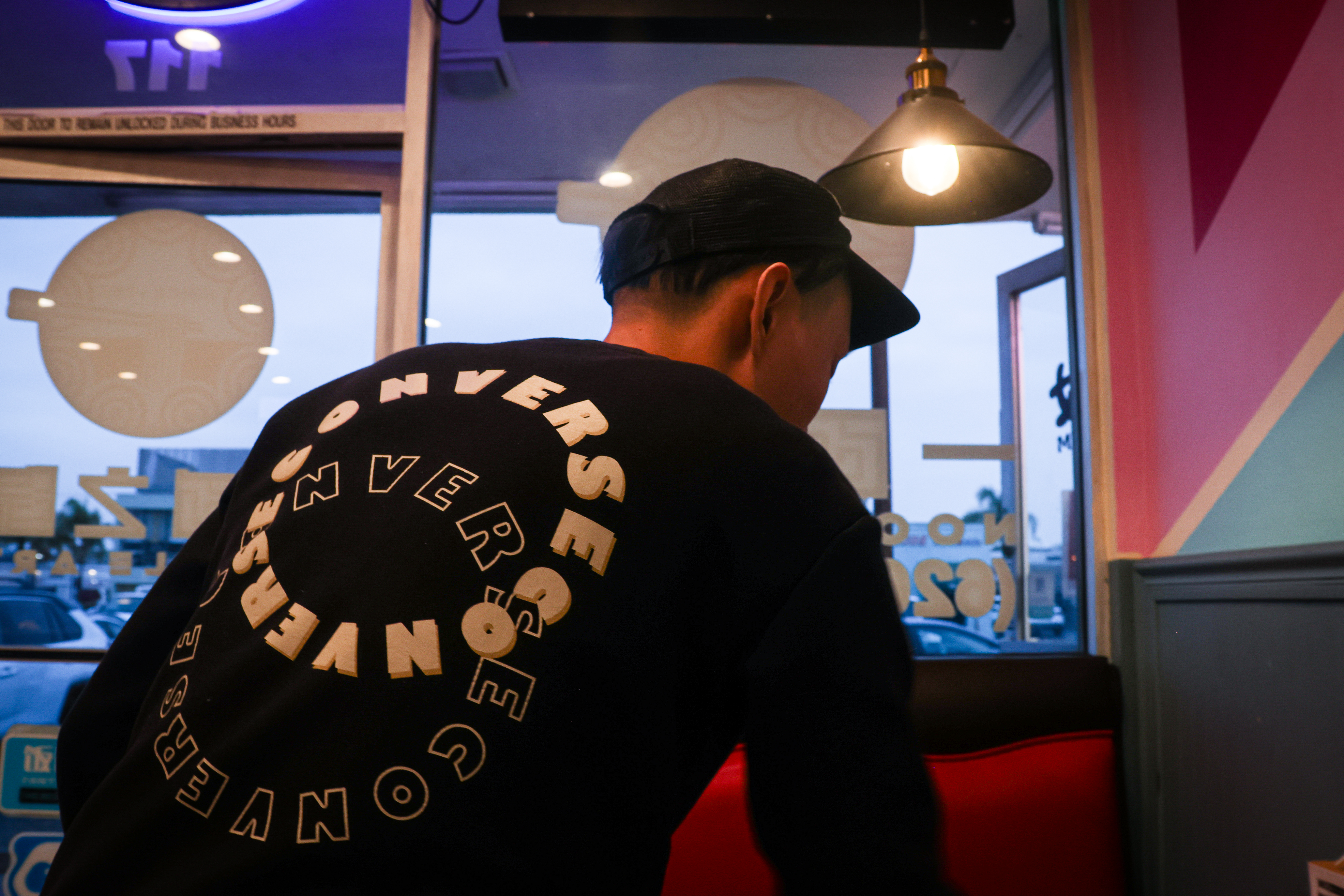 Leo cleans tables at a noodle shop where he works